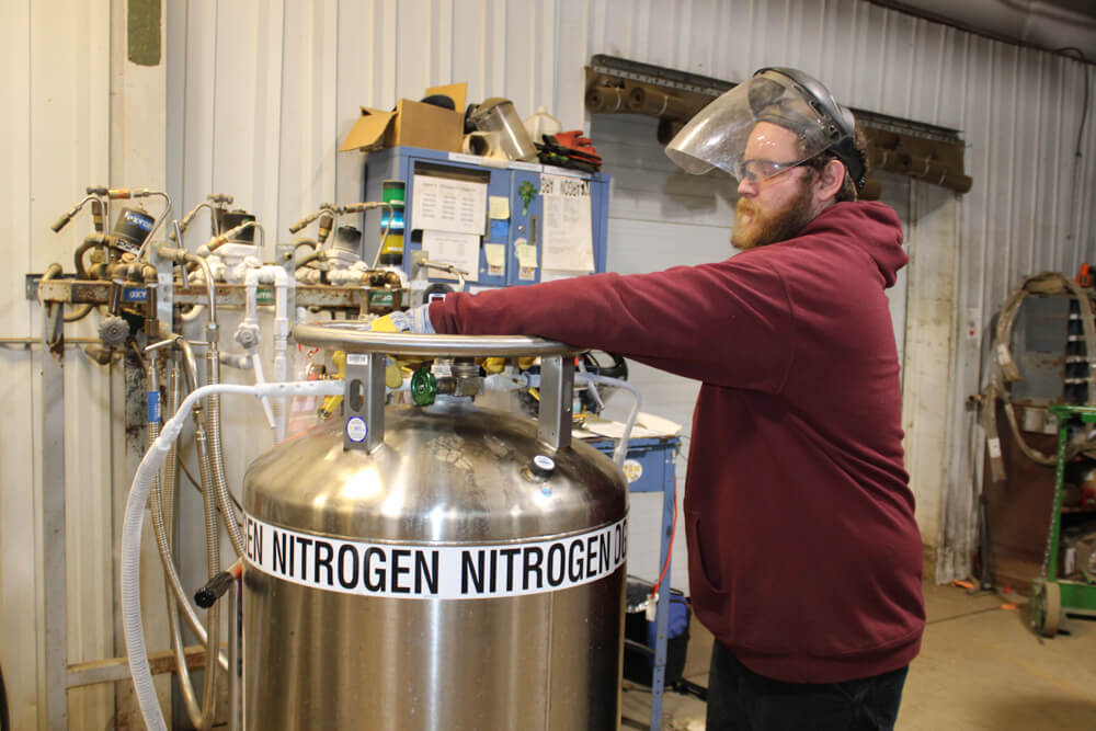 man working with nitrogen tank