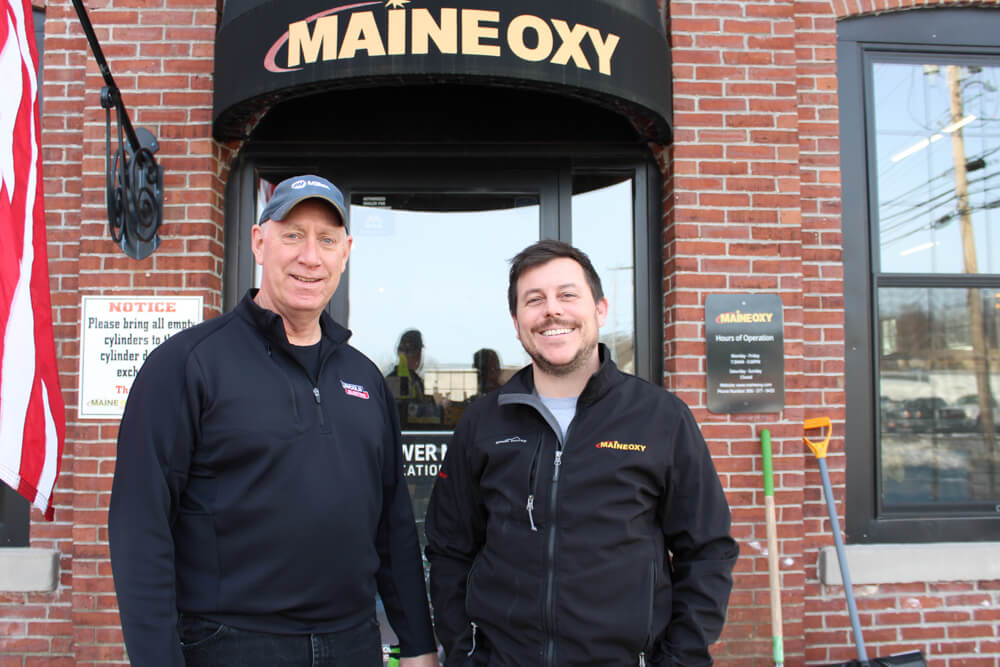 maine oxy team members outside maine oxy office doors