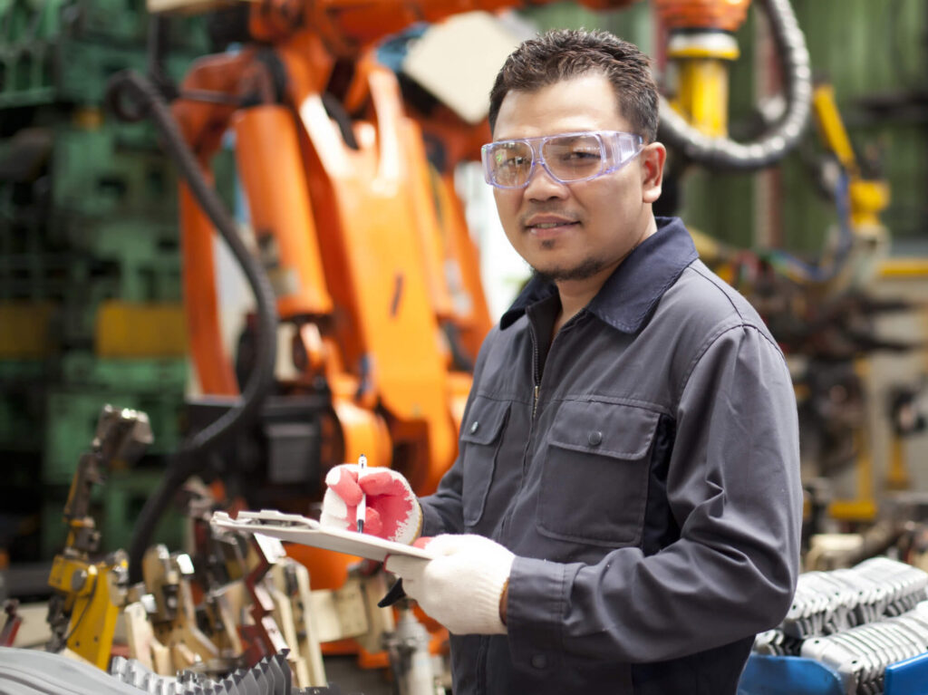 man in safety glass and gloves with clipboard