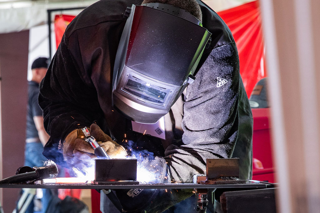 close up of Maine Oxy employee welding